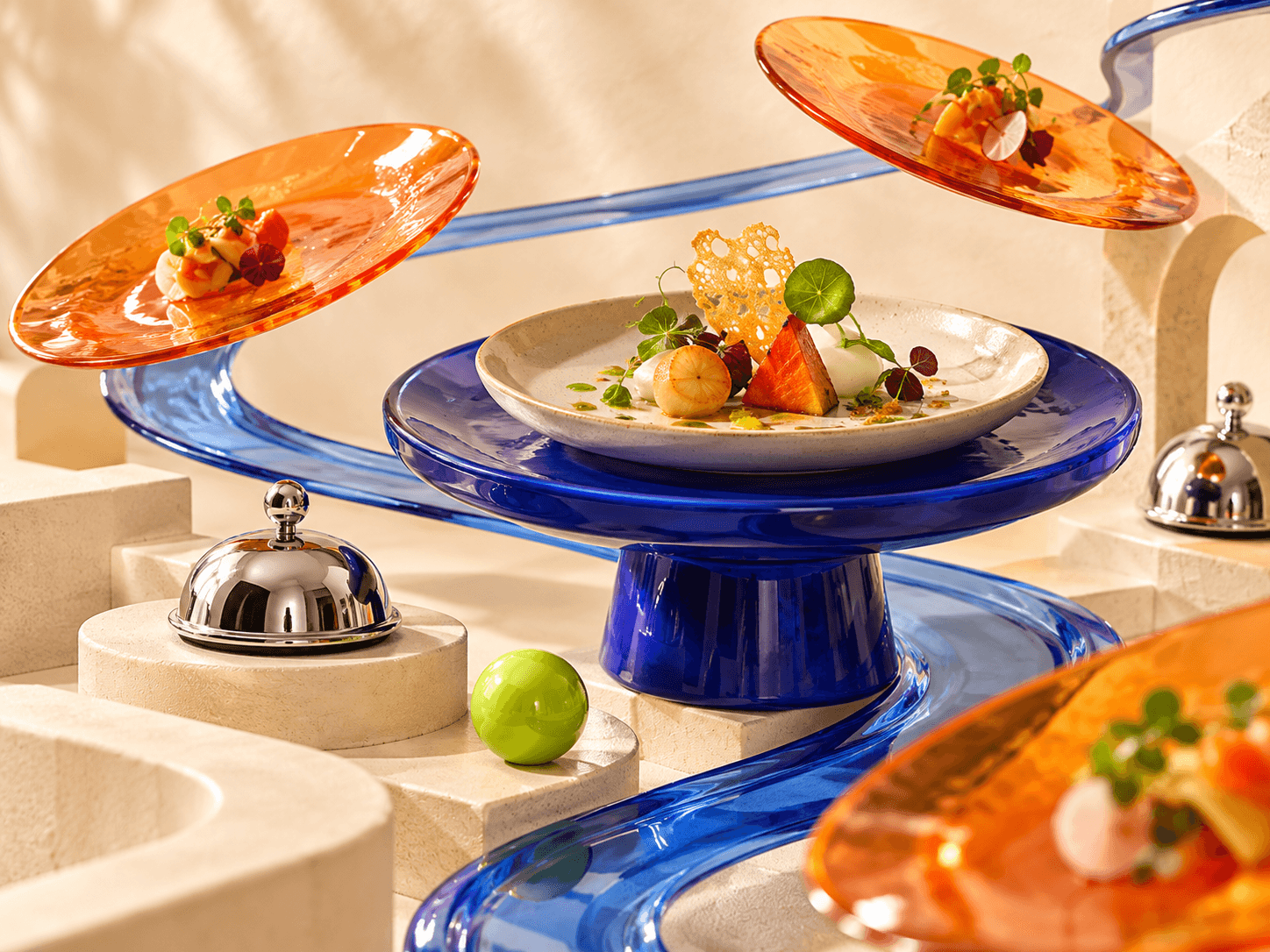 Editorial hospitality still life with sculptural serving platforms and connected pathways